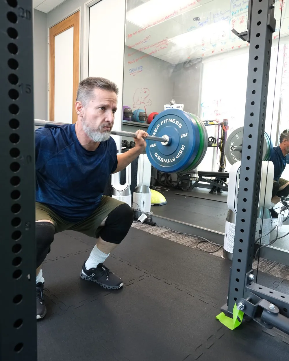 An employee strength training in the on-site office gym