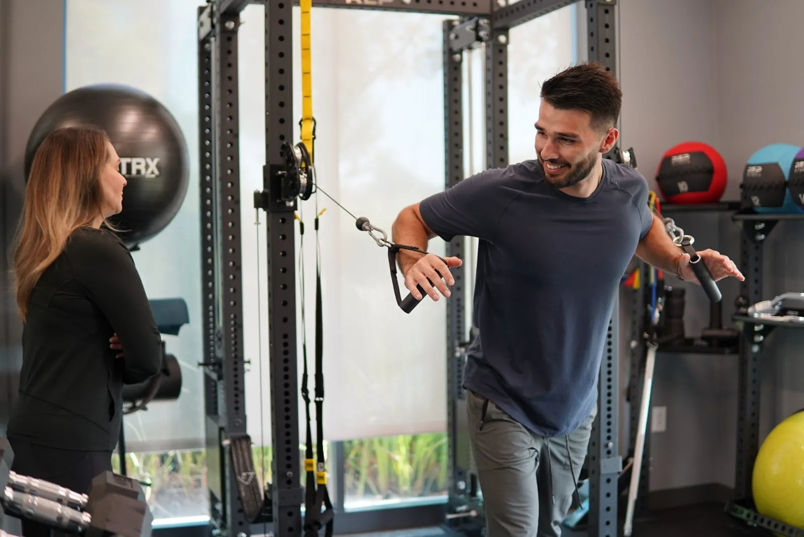 Trainer coaching an employee in the office gym