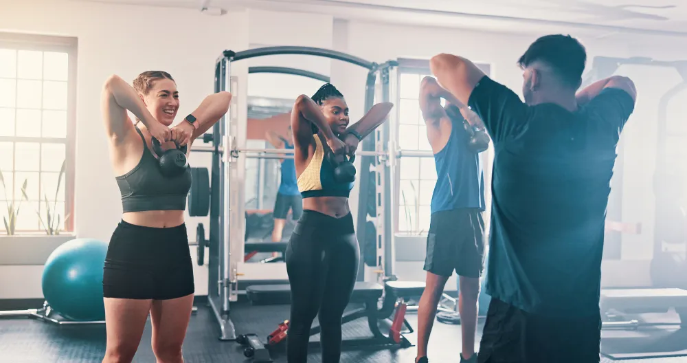 Coworkers stretching together during a group training session